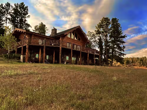 Upper deck and lower cement covered pad at Grandpa’s Place. Exclusive, Stunning, Private Log Home. Firepit & Pond