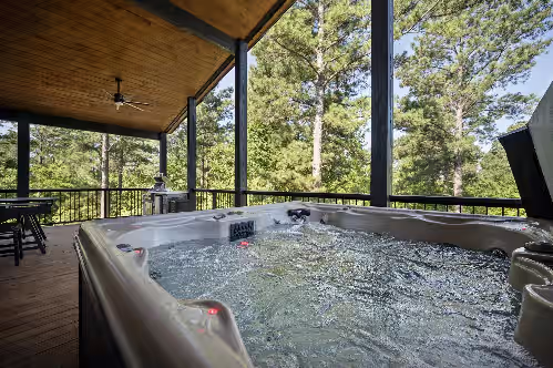 Escape to serenity! Our Broken Bow cabin features an 8-person hot tub on the back deck, offering panoramic views of pine
